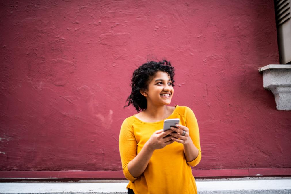 Smiling Young Indian Woman Using Mobile Phone - Arathy Wysa User Story