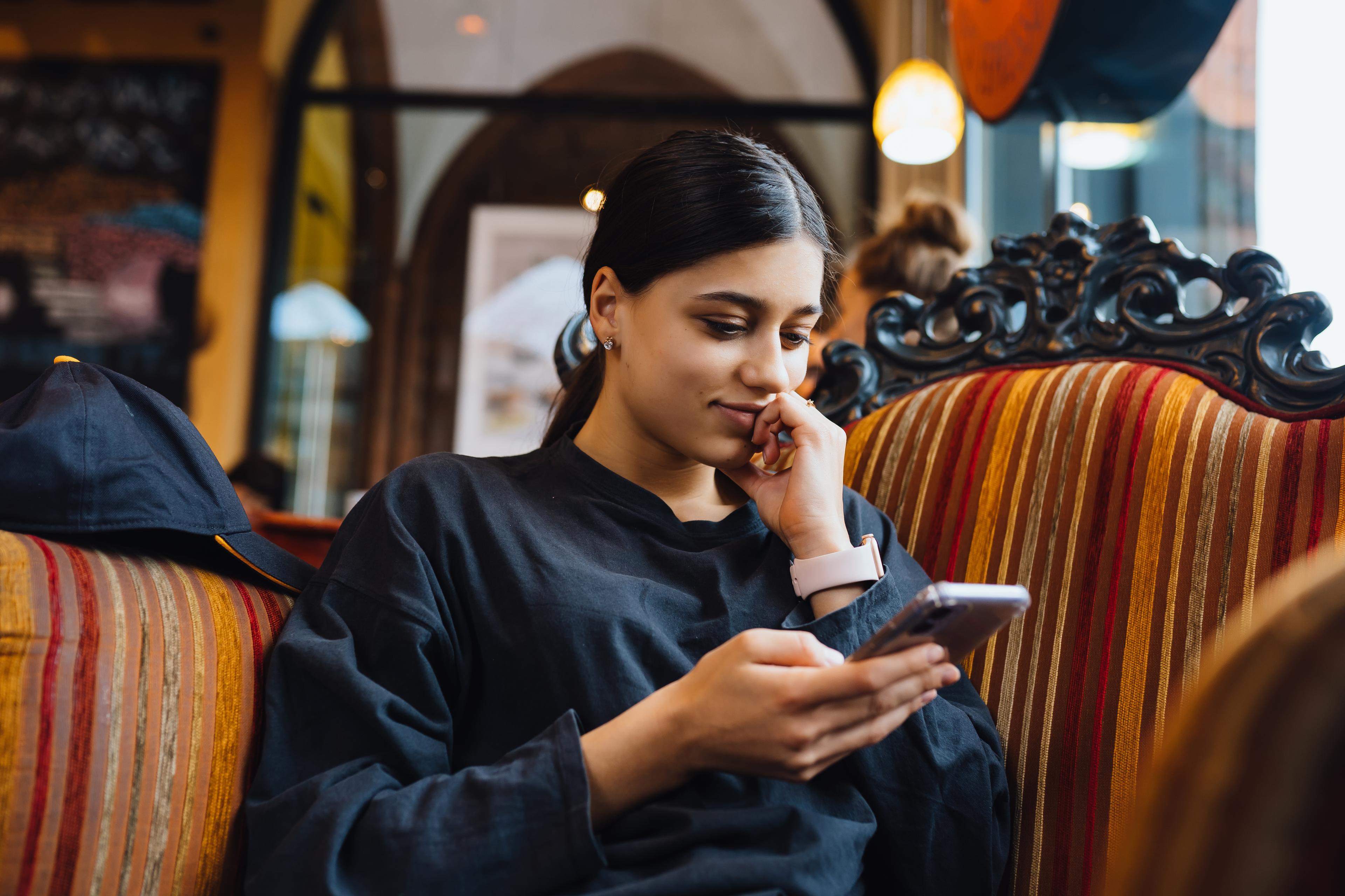 pretty-young-girl-resting-big-soft-chair-cafe-chatting-phone-chatting-time.jpg